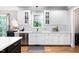 Bright, renovated kitchen features white cabinets, modern stainless steel appliances, and views of the outdoors at 228 Grantwood Dr, Holly Springs, NC 27540
