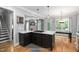 Kitchen island with a cooktop offers seamless transition to the dining area at 228 Grantwood Dr, Holly Springs, NC 27540