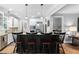 Kitchen island with seating, stainless appliances, and hardwood floors offers a perfect gathering spot at 228 Grantwood Dr, Holly Springs, NC 27540