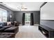 The spacious entertainment area features a projector screen, couch, and natural light at 228 Grantwood Dr, Holly Springs, NC 27540