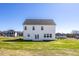 Two-story home showcasing a spacious backyard and well-maintained lawn at 267 Old Fashioned Way, Lillington, NC 27546