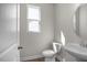 Well-lit powder room featuring a pedestal sink and a window at 267 Old Fashioned Way, Lillington, NC 27546