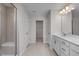 Bathroom featuring a shower with a built-in seat and dual sink vanity at 267 Old Fashioned Way, Lillington, NC 27546