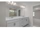 Modern bathroom featuring dual sinks and a full-length mirror at 267 Old Fashioned Way, Lillington, NC 27546