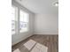 Bright, empty bedroom featuring hardwood floors and windows offering lots of natural light at 267 Old Fashioned Way, Lillington, NC 27546