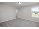 Bedroom featuring plush carpet and view of a fenced-in back yard at 267 Old Fashioned Way, Lillington, NC 27546