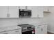 Well-appointed kitchen featuring stainless steel appliances, white cabinets, and sleek countertops at 267 Old Fashioned Way, Lillington, NC 27546