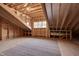 Unfinished attic space showcasing exposed wood framing, a window, and a clean plywood subfloor at 3020 High Plains Dr, Fuquay Varina, NC 27526