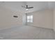 Expansive bedroom with plush carpet, ceiling fan, and a window offering neighborhood views at 3020 High Plains Dr, Fuquay Varina, NC 27526