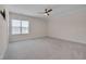 Bright bedroom featuring plush carpet, ceiling fan, and a window bringing in natural light at 3020 High Plains Dr, Fuquay Varina, NC 27526