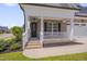 Inviting brick home entrance featuring a covered porch with white railing and a striking black front door at 3020 High Plains Dr, Fuquay Varina, NC 27526