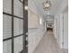 Elegant hallway with light wood floors, wainscoting, and a view into the home's living spaces at 3020 High Plains Dr, Fuquay Varina, NC 27526