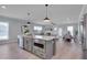 Open-concept kitchen featuring gray cabinets, stainless steel appliances, and large island at 3020 High Plains Dr, Fuquay Varina, NC 27526