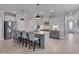 Bright, open kitchen features gray cabinets, stainless appliances, kitchen island with bar stool seating at 3020 High Plains Dr, Fuquay Varina, NC 27526