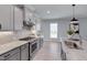 Modern kitchen with gray cabinets, stainless steel appliances, granite counters and a kitchen island with seating at 3020 High Plains Dr, Fuquay Varina, NC 27526