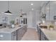 This kitchen is spacious and features stainless appliances, gray cabinets and a center island with pendant lights at 3020 High Plains Dr, Fuquay Varina, NC 27526