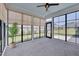 Bright sunroom with black-framed windows, neutral roller shades, a ceiling fan, and comfortable carpet at 3020 High Plains Dr, Fuquay Varina, NC 27526