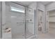 Luxurious walk-in shower with glass enclosure and a built-in bench at 3020 High Plains Dr, Fuquay Varina, NC 27526