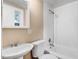 Clean bathroom featuring a white toilet and sink combo with a functional shower/bathtub at 306 Union Ave, Burlington, NC 27217