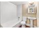 Clean bathroom featuring a tub-shower, white vanity with sink, and tile flooring at 306 Union Ave, Burlington, NC 27217