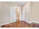 Bedroom featuring hardwood floors, neutral walls, and access to a closet and another room at 306 Union Ave, Burlington, NC 27217