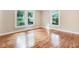 Sun-drenched bedroom with hardwood floors, large windows offering natural light, and freshly painted walls at 306 Union Ave, Burlington, NC 27217