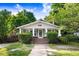Charming home featuring a welcoming front porch, classic architectural details, and a well-maintained lawn at 306 Union Ave, Burlington, NC 27217