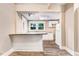 Galley kitchen with white cabinetry, updated countertops, stainless appliances, and breakfast bar at 306 Union Ave, Burlington, NC 27217