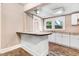 Charming kitchen with white cabinets, granite countertops, and a breakfast bar for added functionality at 306 Union Ave, Burlington, NC 27217