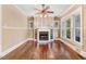 Bright and airy living room boasts hardwood floors, fireplace, and lots of natural light from the large windows at 306 Union Ave, Burlington, NC 27217