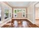 Bright and airy living room boasts hardwood floors, neutral paint and lots of natural light from the large windows at 306 Union Ave, Burlington, NC 27217
