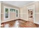 Bright and airy living room boasts hardwood floors, neutral paint and lots of natural light from the large windows at 306 Union Ave, Burlington, NC 27217