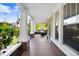 Inviting front porch with brick columns, tile flooring, and views of the surrounding greenery at 306 Union Ave, Burlington, NC 27217