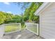 Backyard deck with white railings overlooking a lush green lawn and storage shed at 307 W Austin St, Mebane, NC 27302