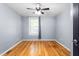 This bedroom offers hardwood floors, a ceiling fan, and a window with natural light at 307 W Austin St, Mebane, NC 27302
