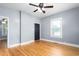 This spacious bedroom features hardwood floors, a ceiling fan, and a window letting in natural light at 307 W Austin St, Mebane, NC 27302