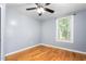 The bright bedroom has hardwood floors, light gray walls, and a large window at 307 W Austin St, Mebane, NC 27302