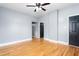 A spacious empty room features gray walls, hardwood floors, white trim, and a black door at 307 W Austin St, Mebane, NC 27302