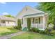 Charming home featuring a manicured lawn, brick walkway, and covered porch with white railing and green accents at 307 W Austin St, Mebane, NC 27302