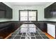 The kitchen boasts tiled countertops, black cabinetry, and ample natural light at 307 W Austin St, Mebane, NC 27302