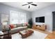 Cozy living room with a modern sofa, decorative pillows, wood furniture, rug and hardwood floors at 307 W Austin St, Mebane, NC 27302