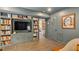 Basement with built-in bookcase, TV, and quirky art for a cozy and functional living space at 3308 Cobblestone Court Ct, Raleigh, NC 27607
