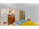 Bright bedroom with an ensuite bathroom, hardwood furniture, white walls, and natural light from windows at 3308 Cobblestone Court Ct, Raleigh, NC 27607