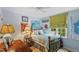 Comfortable bedroom with blue walls, a ceiling fan, natural light, and decorated with sports memorabilia at 3308 Cobblestone Court Ct, Raleigh, NC 27607