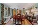 Bright dining room featuring an extended dining table and windows with floral curtains at 3308 Cobblestone Court Ct, Raleigh, NC 27607