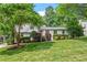 Charming two-story home with a lush green lawn, mature trees, and well-manicured shrubs at 3308 Cobblestone Court Ct, Raleigh, NC 27607