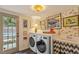 Bright laundry room with stylish wallpaper, modern appliances, and functional sink area at 3308 Cobblestone Court Ct, Raleigh, NC 27607