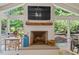 Bright living room featuring a stone fireplace, large windows, and views of the landscaped backyard at 3308 Cobblestone Court Ct, Raleigh, NC 27607