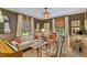 Well-decorated living room features unique wallpaper, comfortable seating, stylish lighting, and natural light from windows at 3308 Cobblestone Court Ct, Raleigh, NC 27607