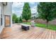 Enjoyable back deck area with a grill, seating, and a well-maintained lawn for outdoor entertaining at 337 Botan Way, Hillsborough, NC 27278